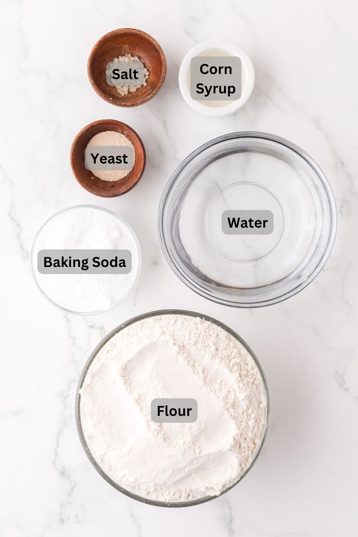 portion bowls each with raw ingredients to make big soft pretzels.