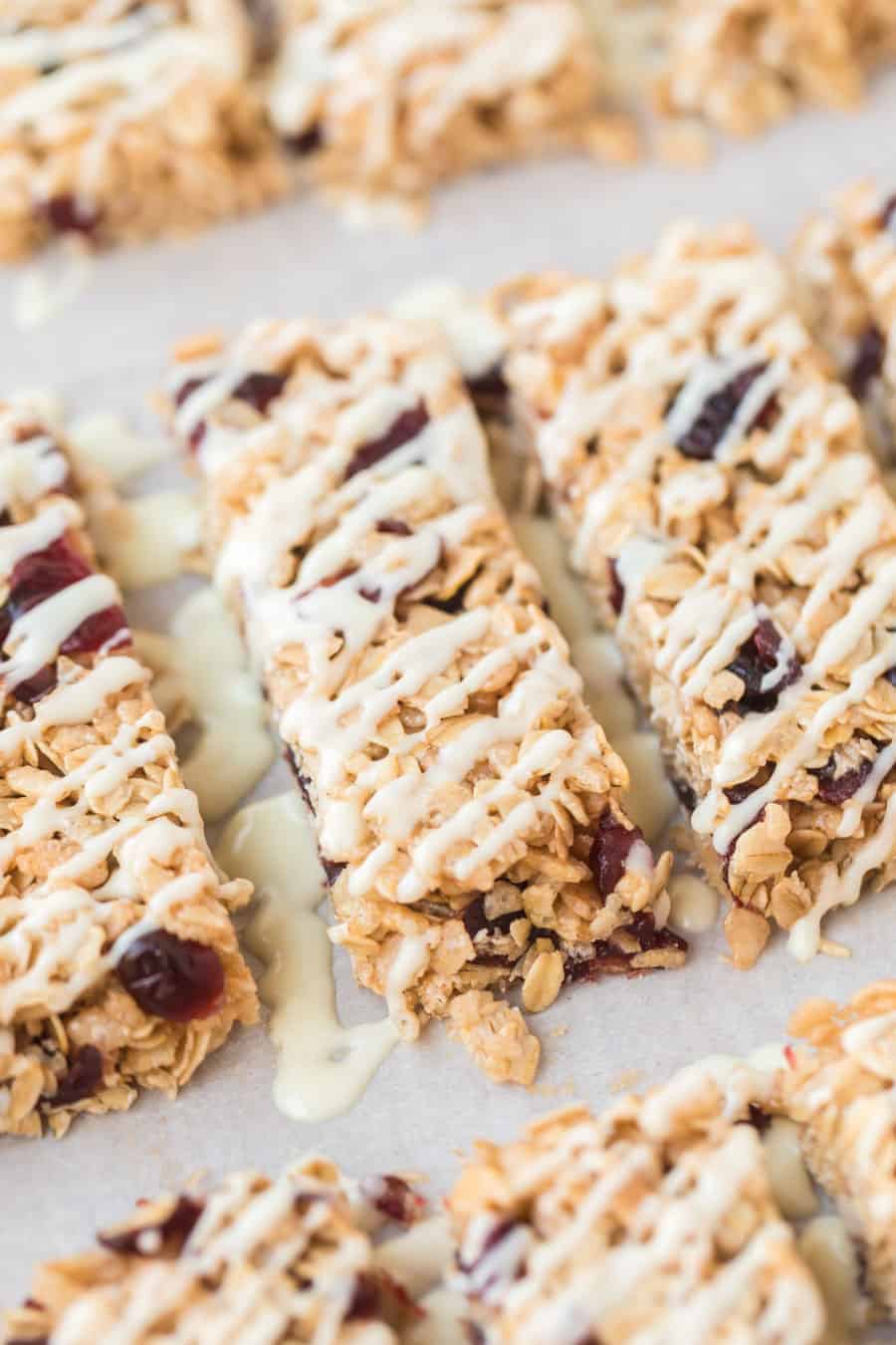 rectangles of cranberry granola bars on parchment.