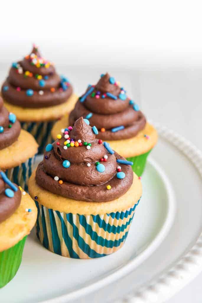 chocolate buttercream icing on cupcakes with sprinkles