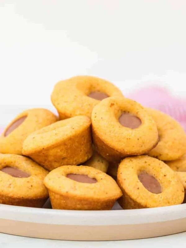 a plate of stacked muffin shaped mini corn dogs