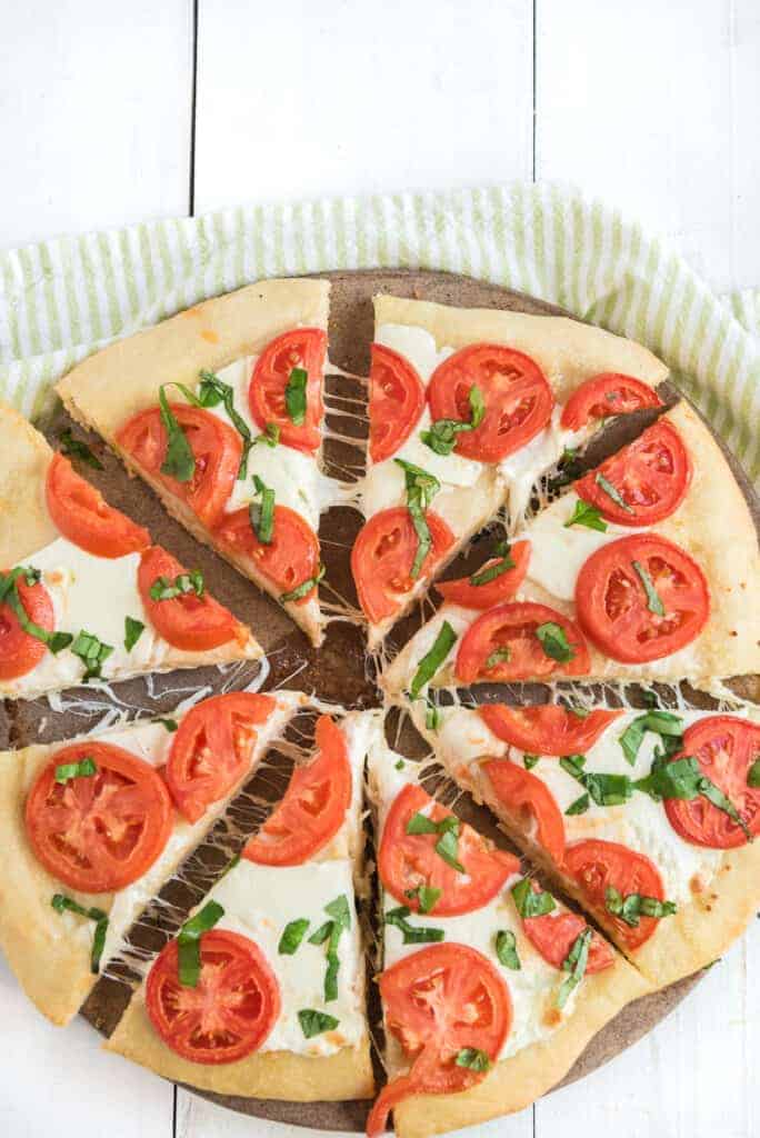 un baked tomatoes and balsamic reduction spread over a classic margarita pizza