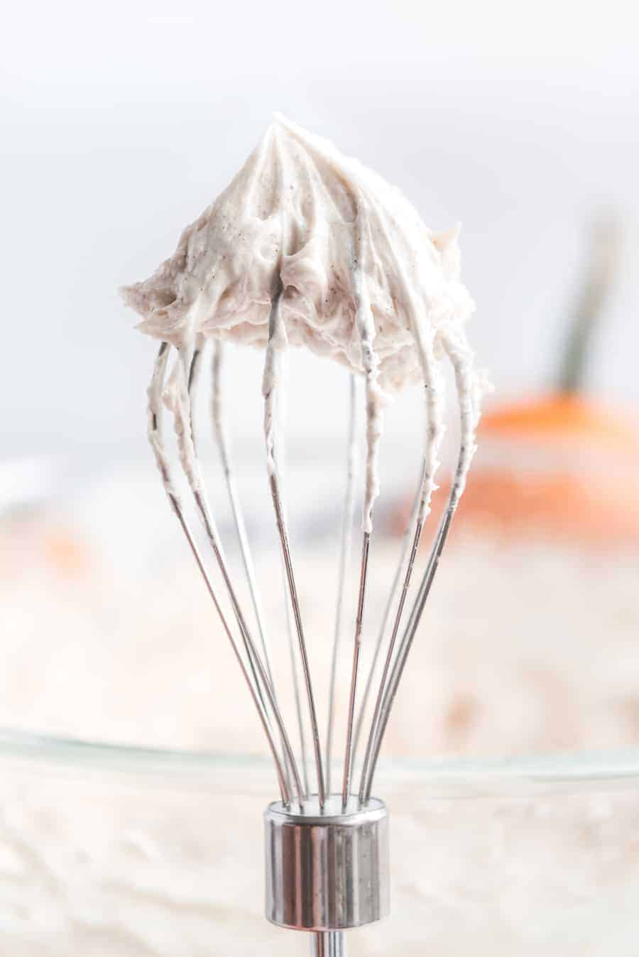 cinnamon whipped icing on a whisk.