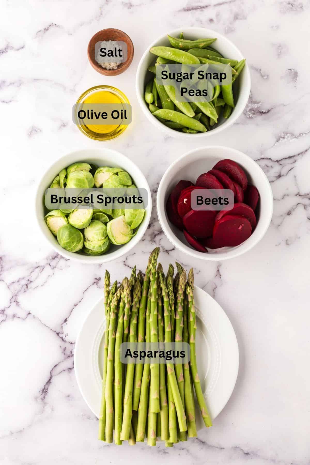 portion bowls each with raw ingredients to make roasted spring vegetables.
