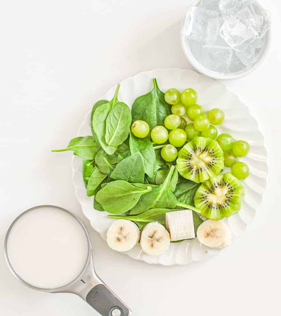 spinach with kiwi and bananas and green grapes ready for smoothie