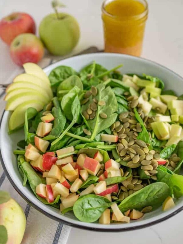 A bowl of spinach apple salad