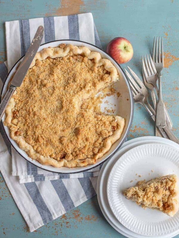 Image of a Dutch Apple Pie with One Slice on a Plate.