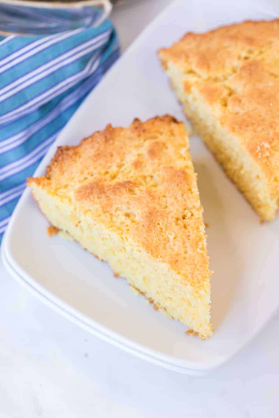 close up of slices taken from a cornbread cake in the shape of a pie on a white plate