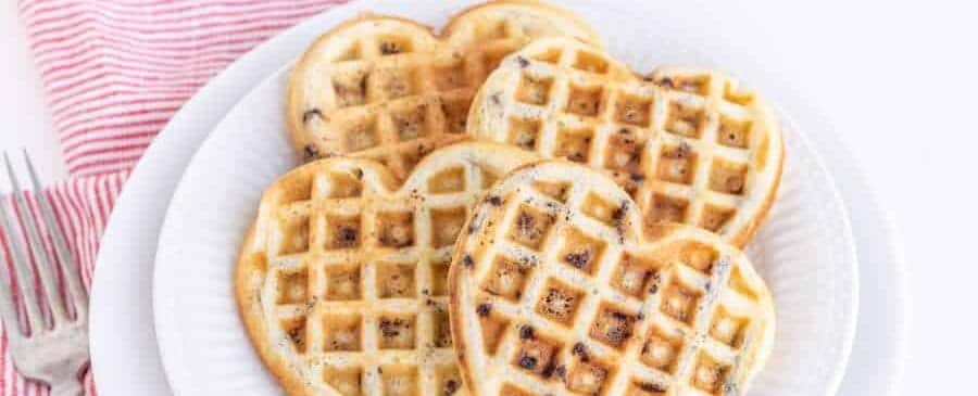 heart shaped chocolate chip waffles on a white plate