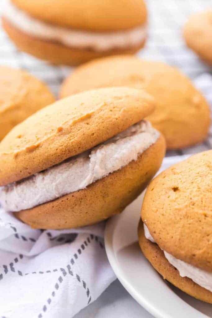 golden top and bottom with cinnamon speckled cream filling two whoopee pies stacked on top of each other