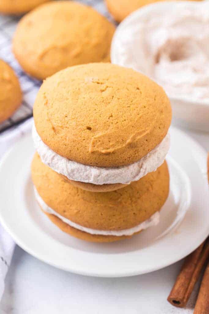 golden top and bottom with cinnamon speckled cream filling two whoopee pies stacked on top of each other