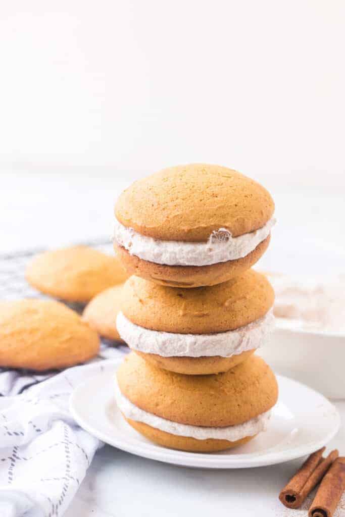 a cute stack of three cream filled whoopee pies on a white plate