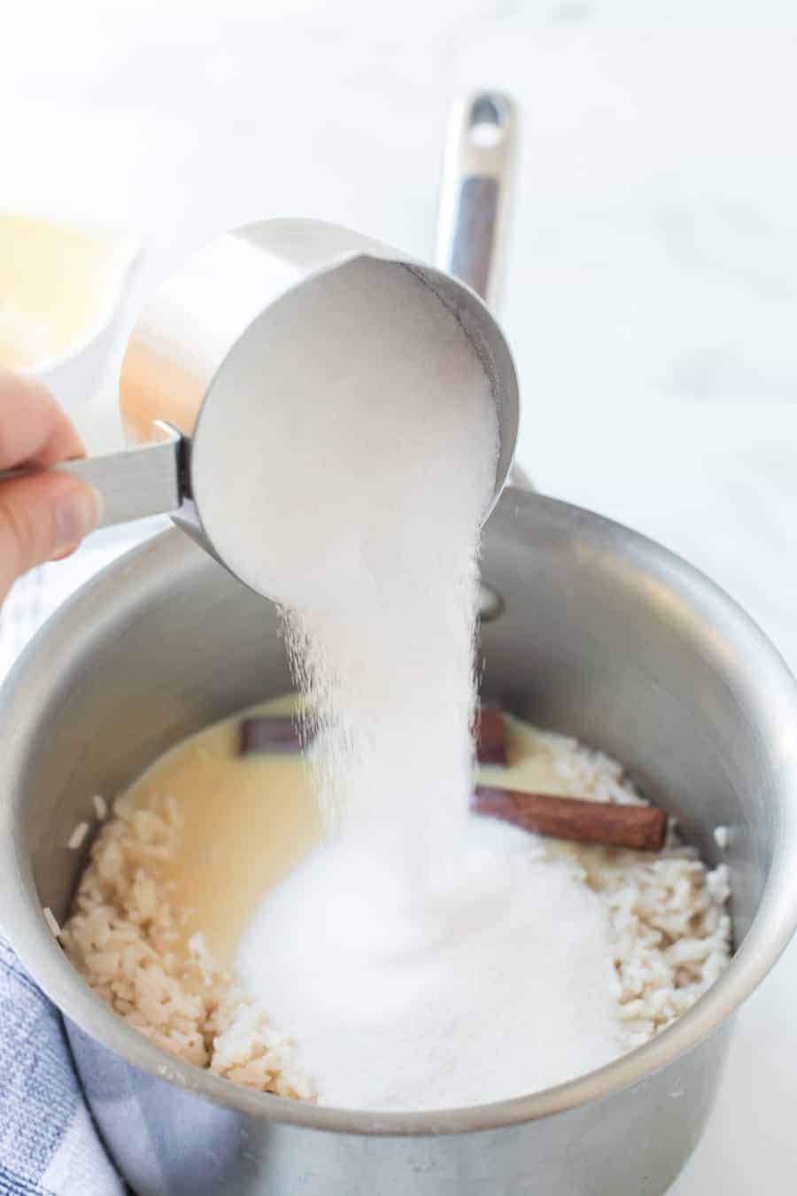 sugar being mixed into the cinnamon and rice pudding mixture.