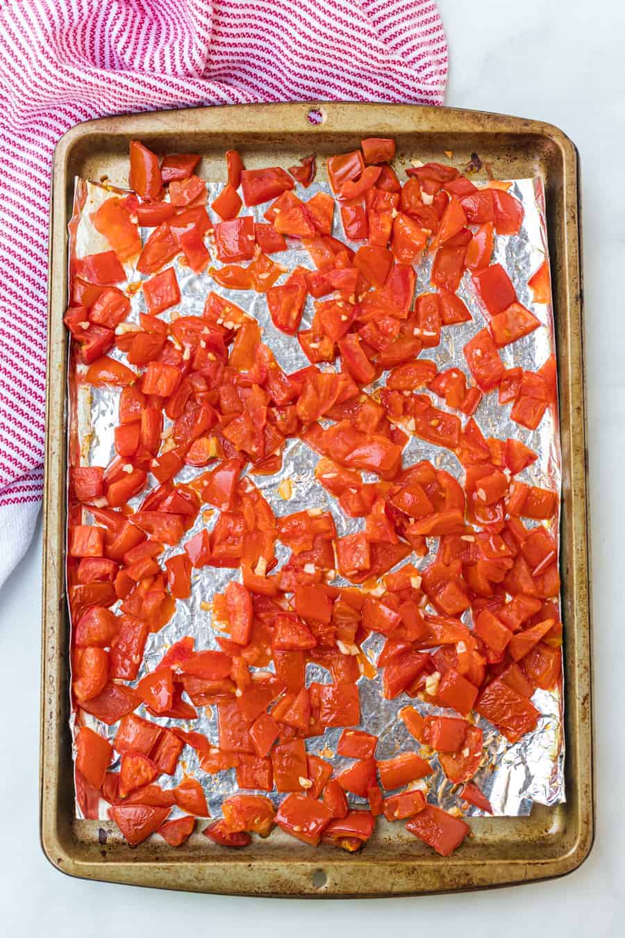 roasted tomato chunks on a baking dish.
