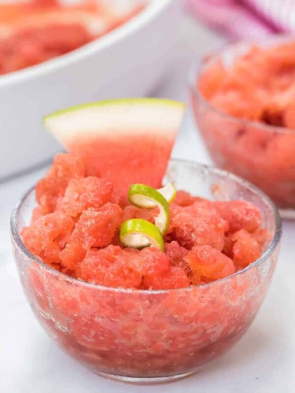 watermelon granita in a clear dish with a lime twist