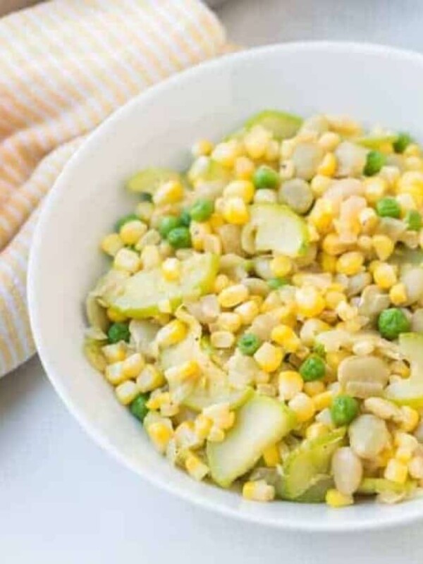 corn and yellow squash side dish in a white bowl