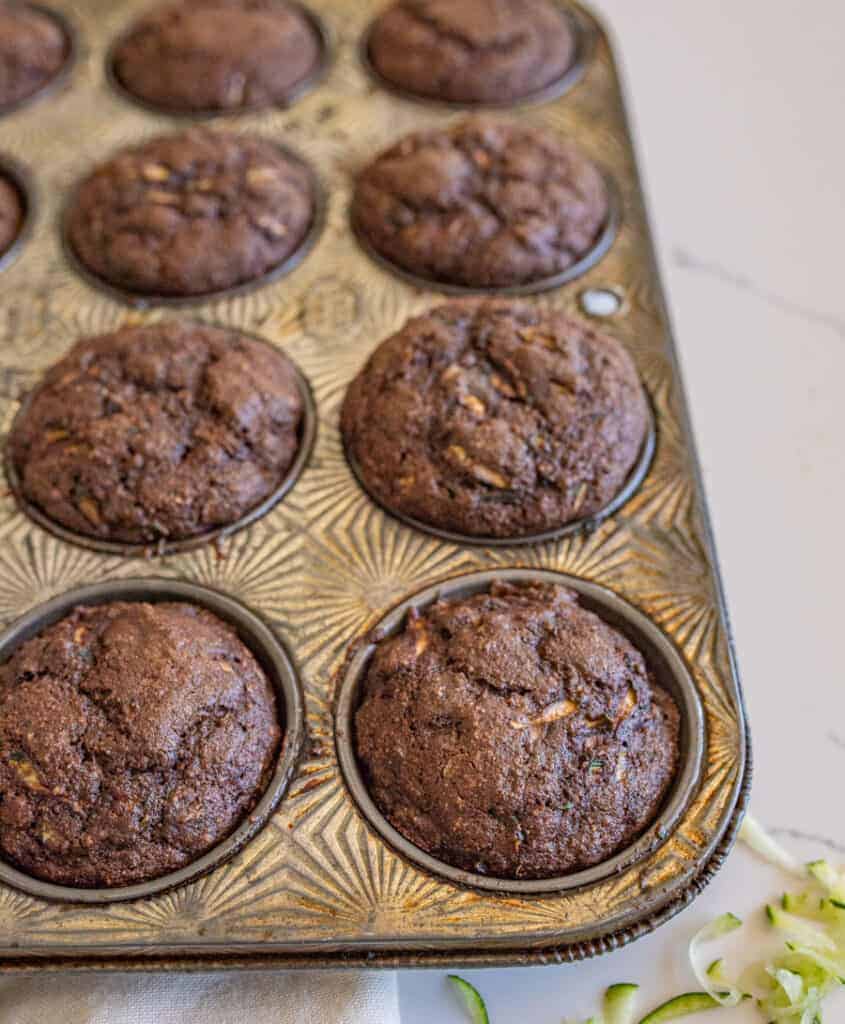 chocolate zucchini muffins in a small muffin tin