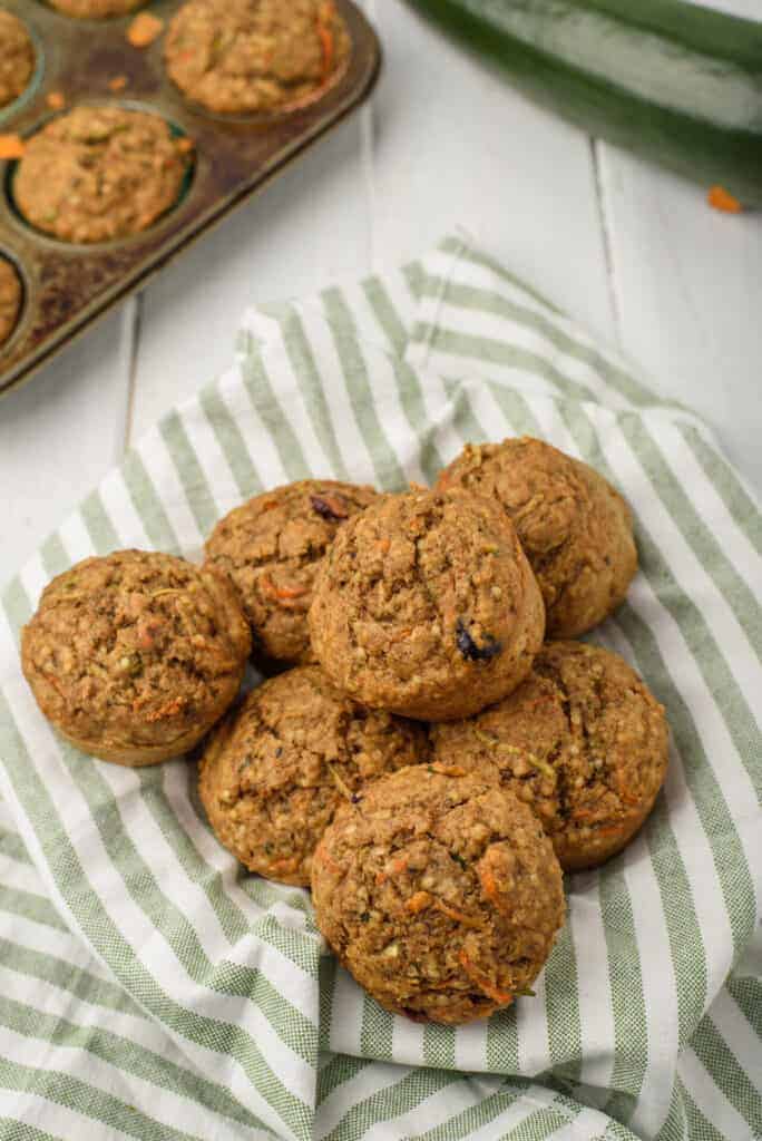 a pile of healthy carrot cake zucchini muffins