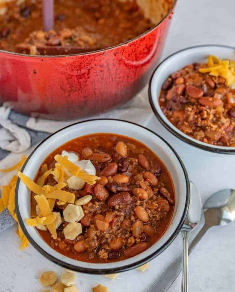 two bowls of chili in white bowls