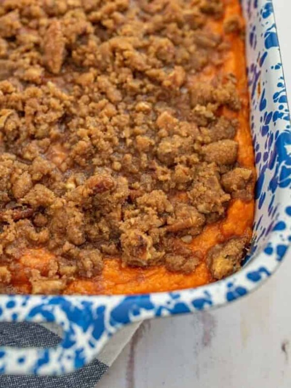 close up of sweet potato casserole in a blue and white pan