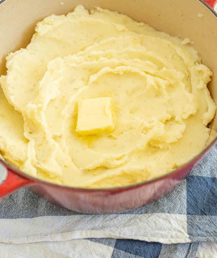mashed potatoes with butter in a red bowl