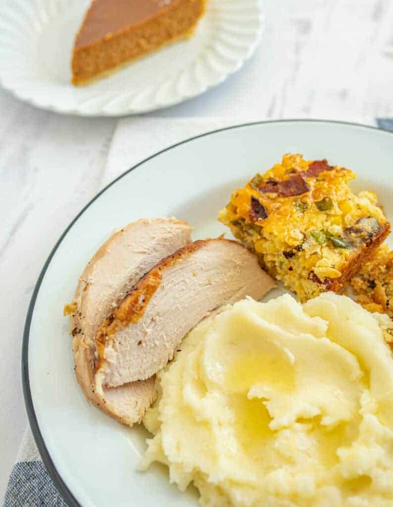 urkey stuffing and mashed potatoes on a white circular plate
