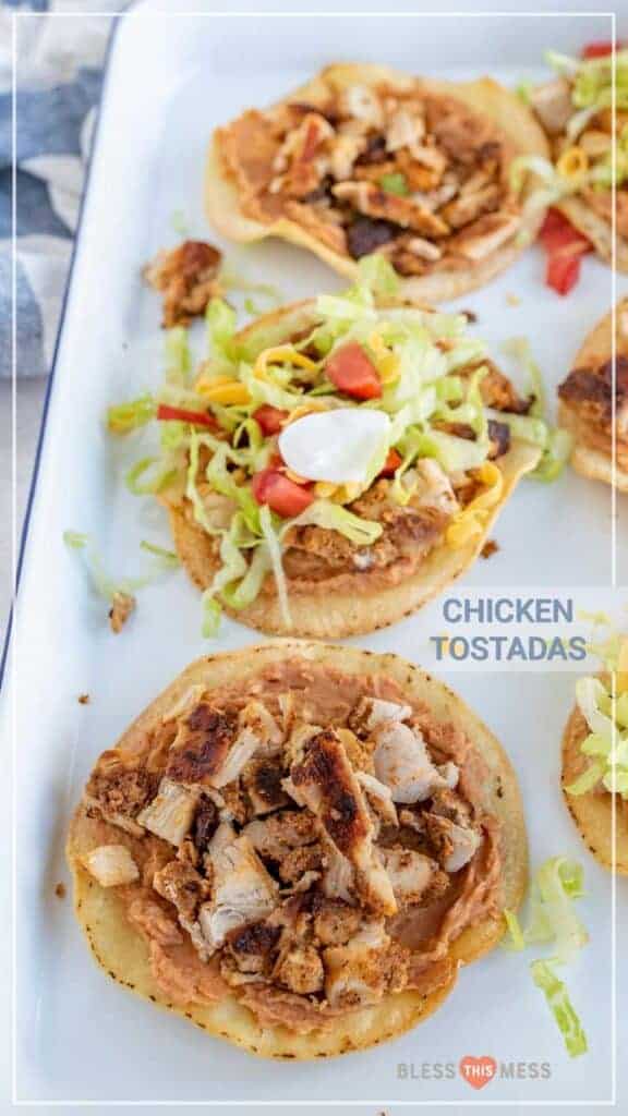 text reads "chicken tostadas" with ingredients piled onto crisp corn tortillas