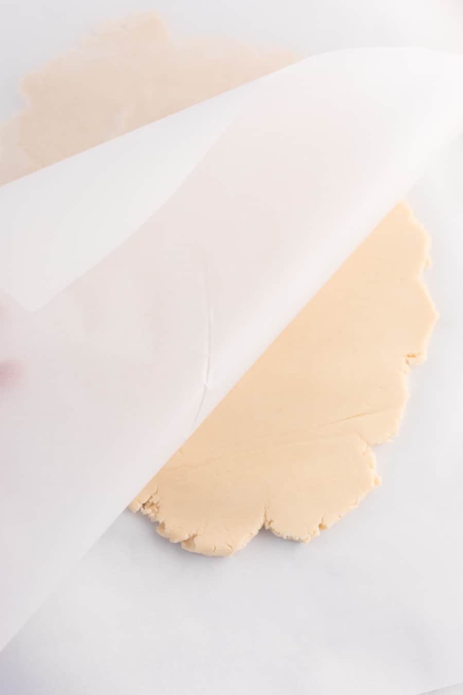 shortbread cookie dough between parchment.