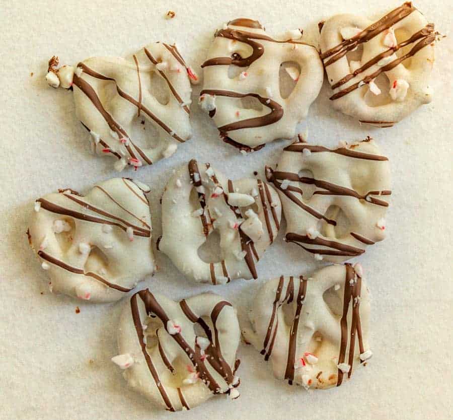 pretzels with white chocolate drizzled with milk chocolate and sprinkled with broken candy canes.