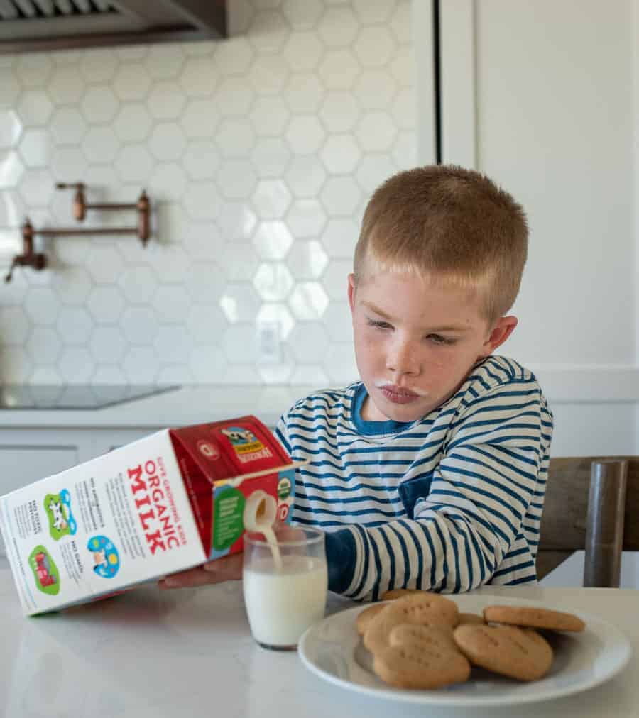 little boy eating milk with homemade graham crackers