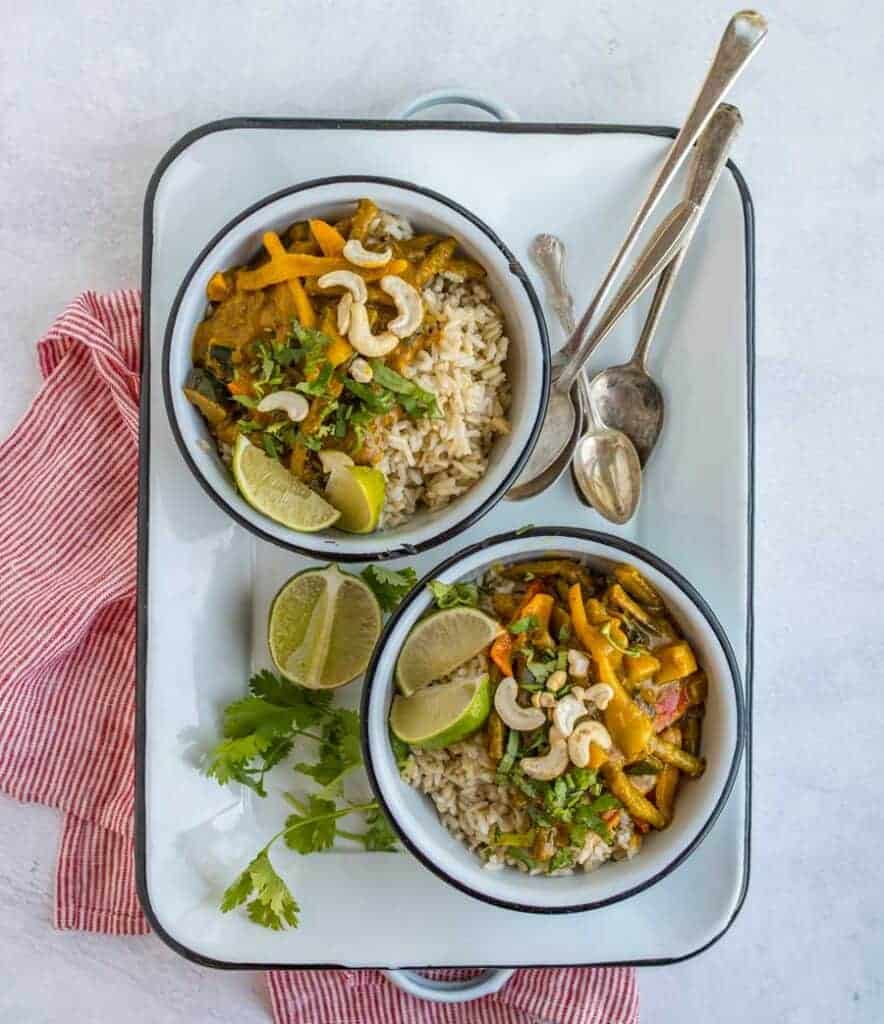 two bowls of easy vegetable curry with spoons top view