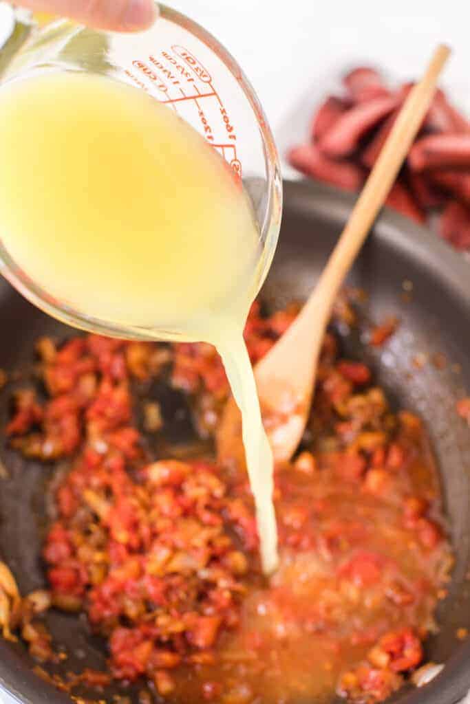 lentils and a tomato and spicy looking sauce in a pan
