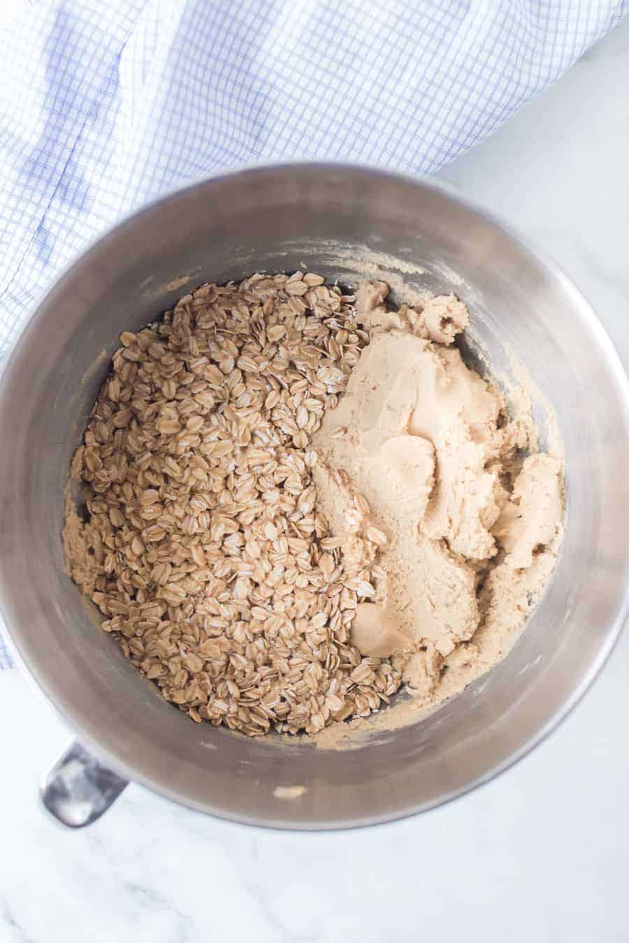 oatmeal cookie batter ingredients in a metal mixer.