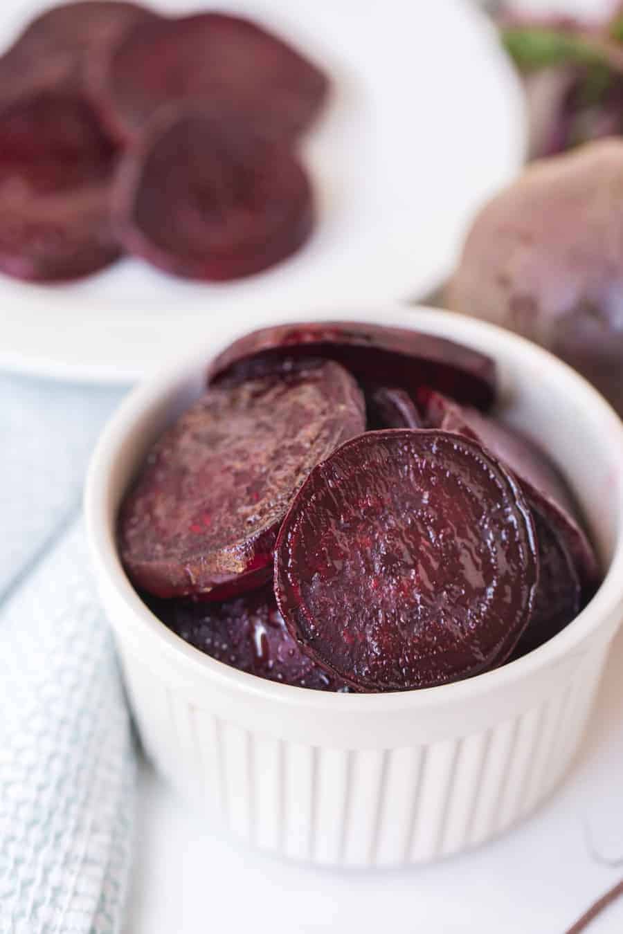 pile of roasted beet slices in a little white dish.