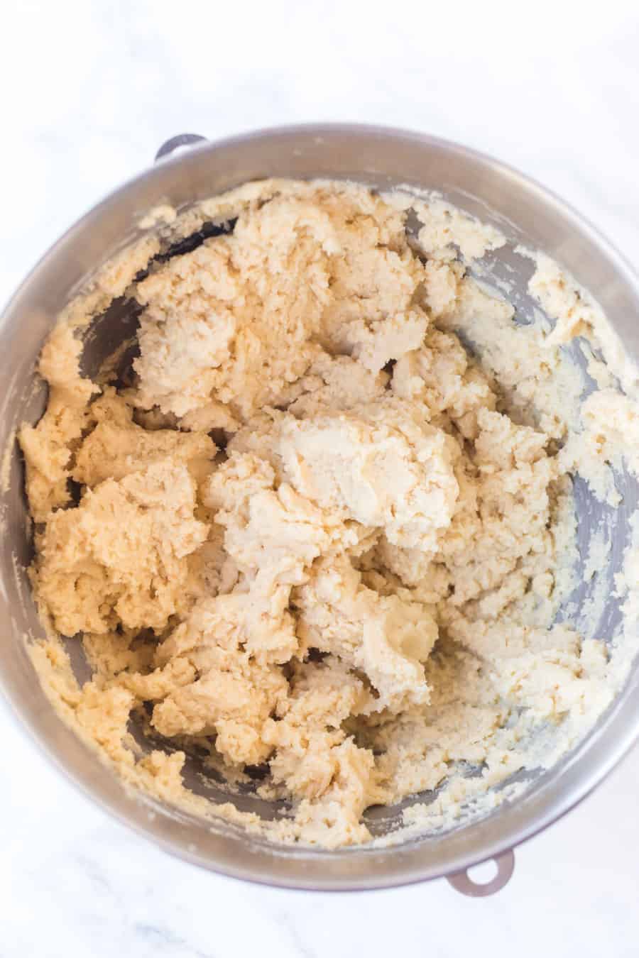 sugar cookie dough in a metal mixing bowl.