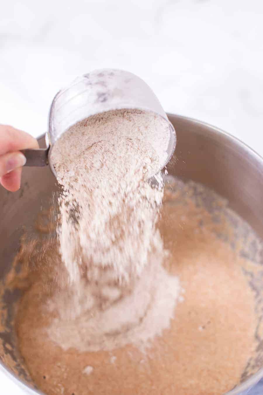 adding flour to bread reciepe.