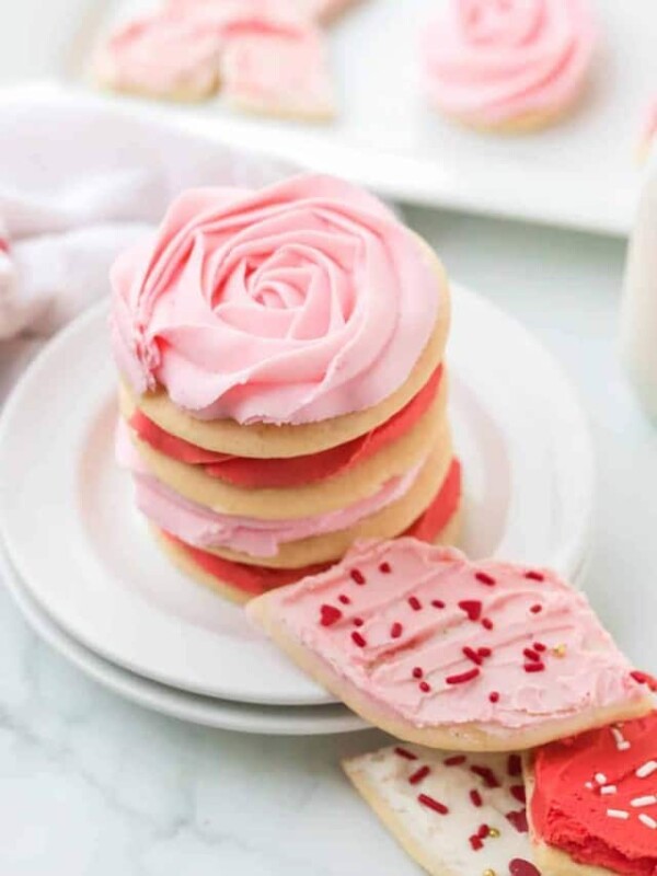 stack of valentines day sugar cookies with piped pink and red roses made of frosting