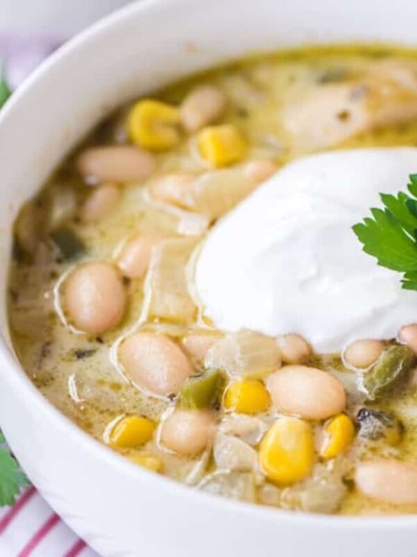 round white bowl with white bean chicken chili on red striped towel