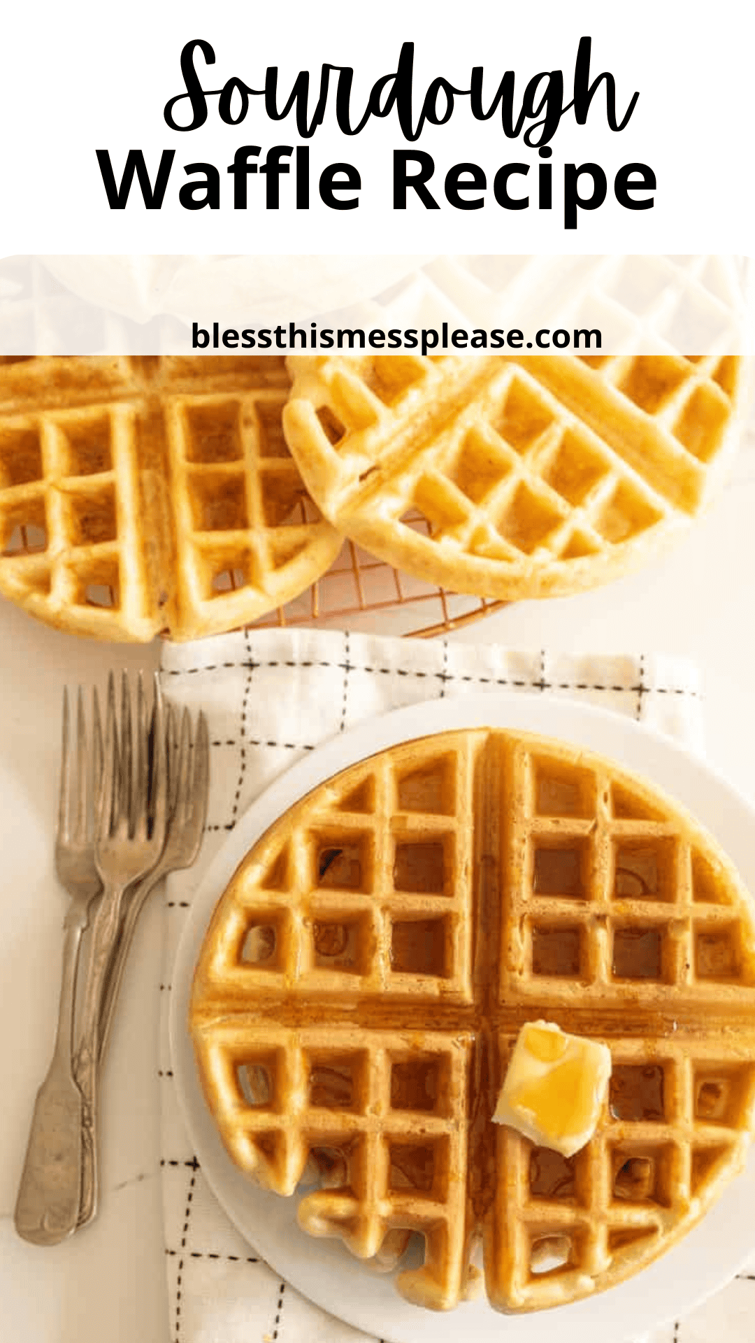 A plate with sourdough waffles, one topped with a pat of butter. Two forks rest beside the plate on a checkered cloth, ready for sampling. More waffle pieces await at the top. Text reads Sourdough Waffle Recipe above blessthismessplease.com—your go-to site for this delightful creation.