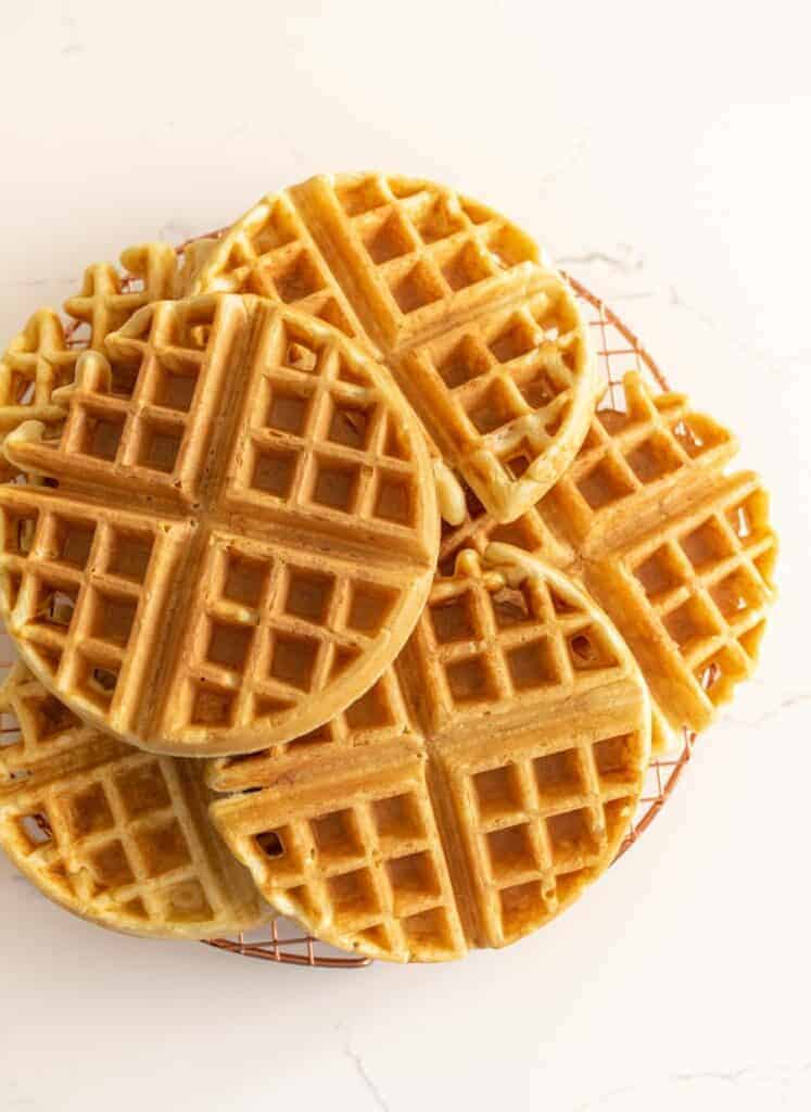 sourdough waffles on a cooking rack made with a sourdough waffle recipe.