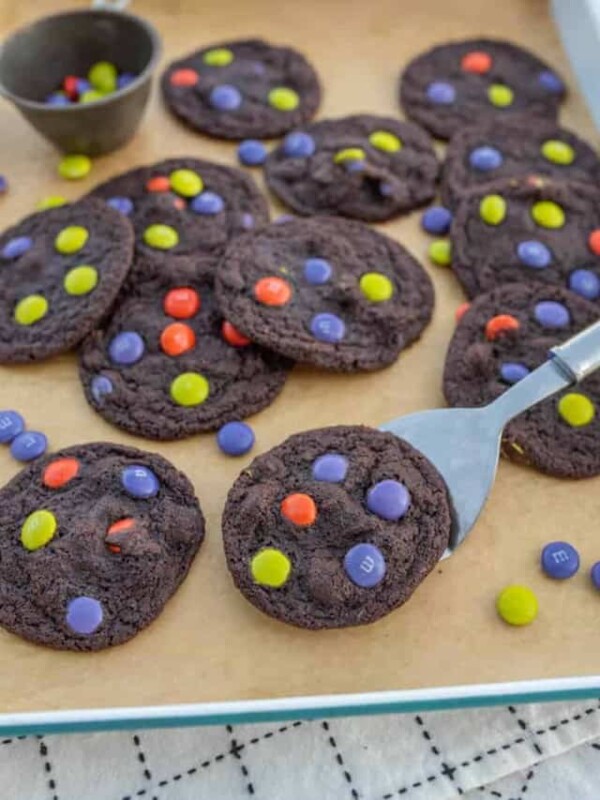 baking sheet filled with dark chocolate halloween M&M cookies