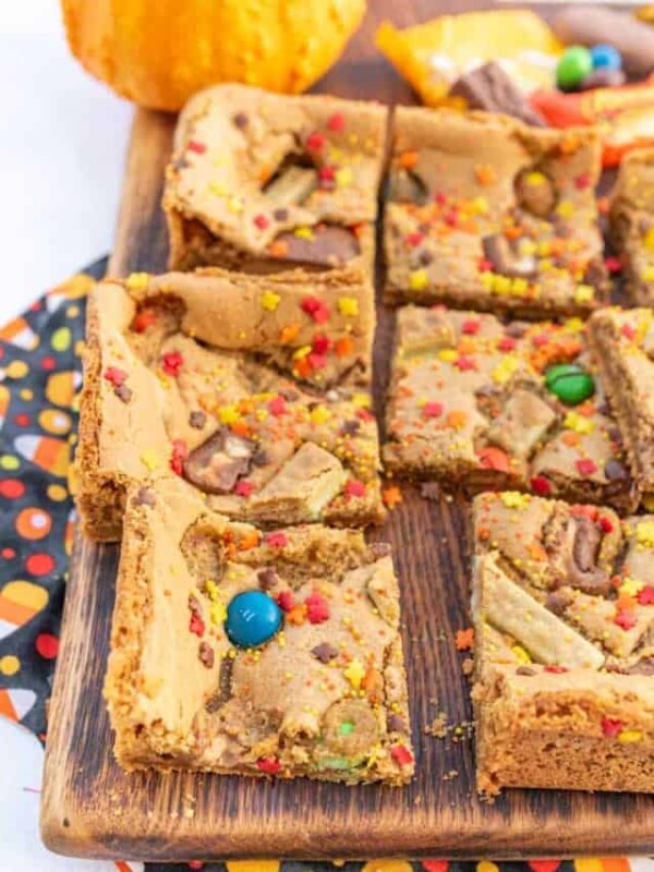 halloween cookie bars with lots of assorted halloween candy on top