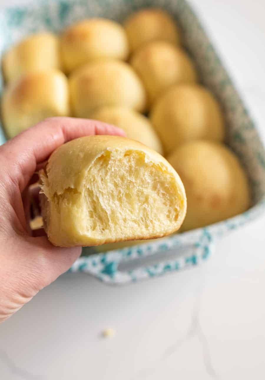 sourdough dinner rolls in hand.