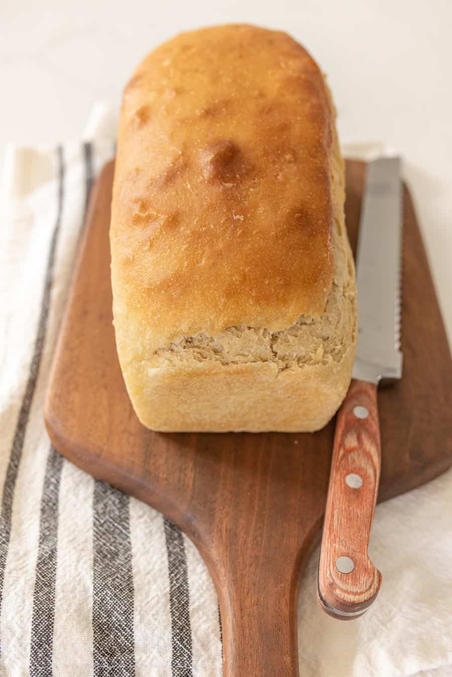 perfect sandwich size loaf of sourdough bread uncut.