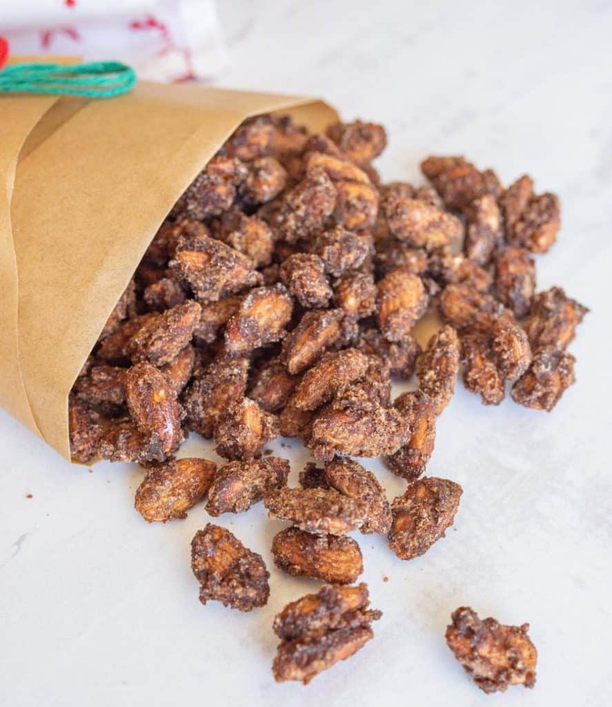 candied almonds spilling out of brown bag