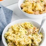 two bowls of chicken stew and a spoon