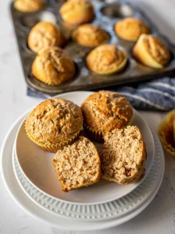 top view of fresh out of the oven bran muffins in tin and some on a plate split open