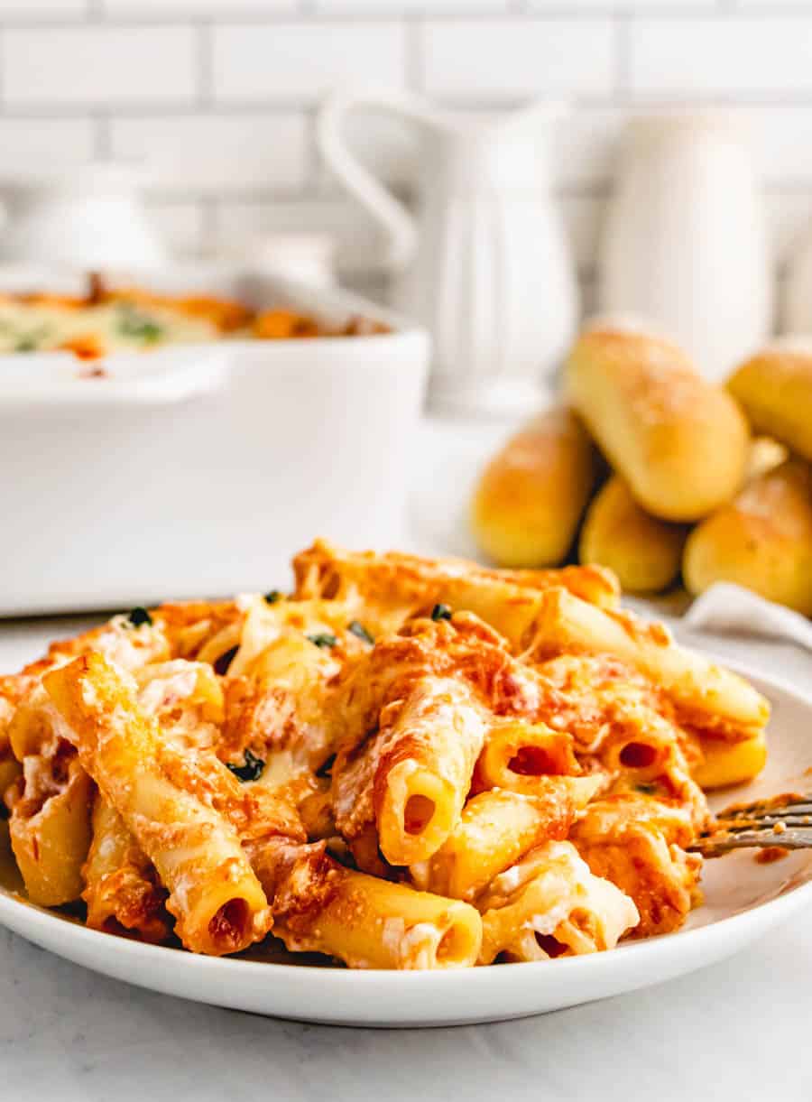 A close up of a plate of a plate of baked ziti. 
