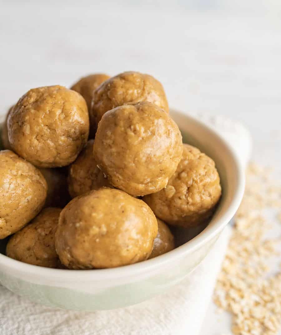 Close up of peanut butter protein balls in a white bowl. 