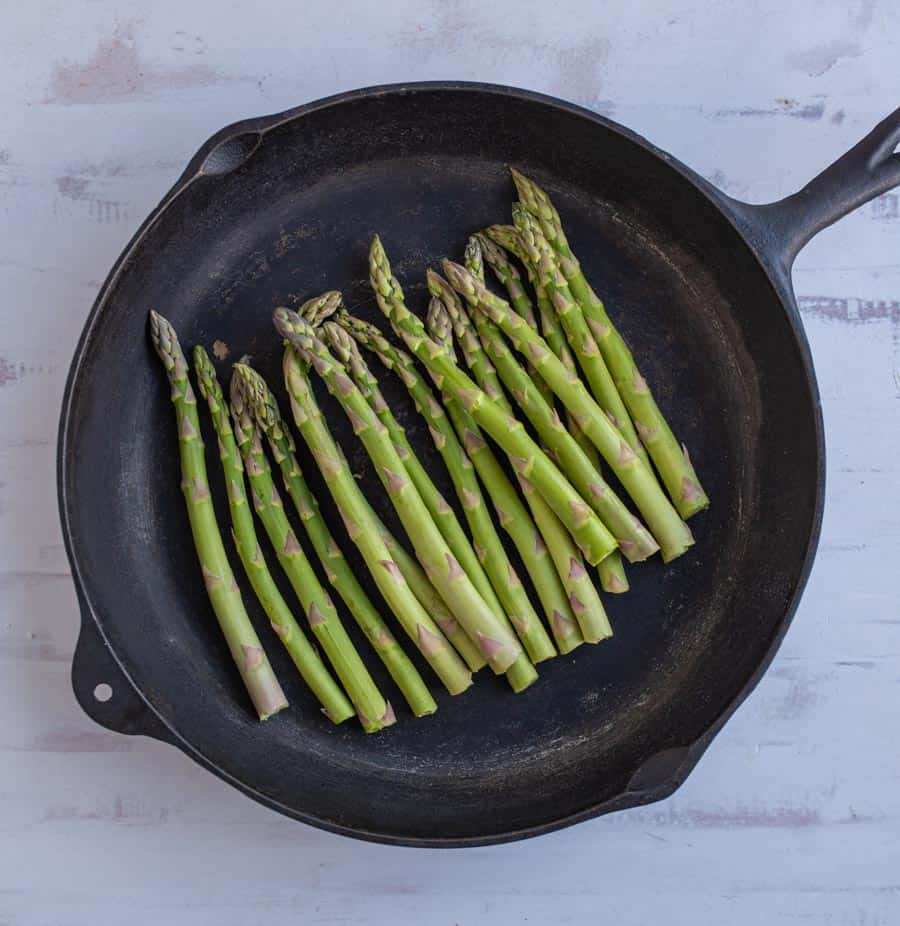 top view of asparagus in a cast iron pan