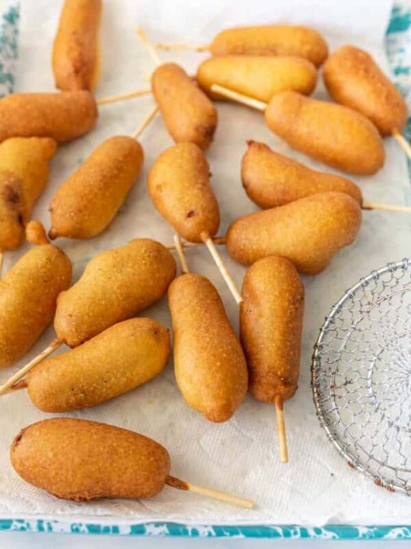 close up picture of corndogs on a tray lined with paper towel